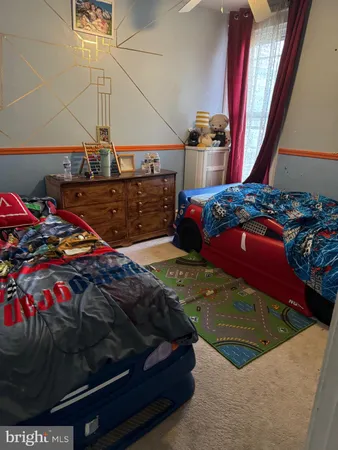 a bedroom with a bed and a painting on the wall