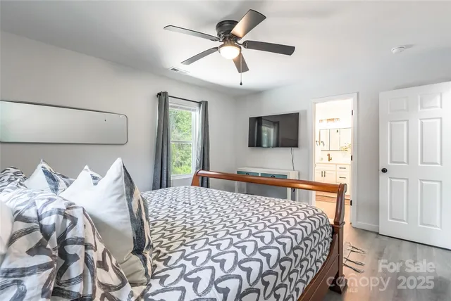 a bedroom with a bed and a flat screen tv