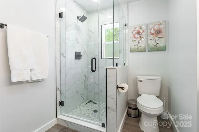 a bathroom with a toilet and a shower