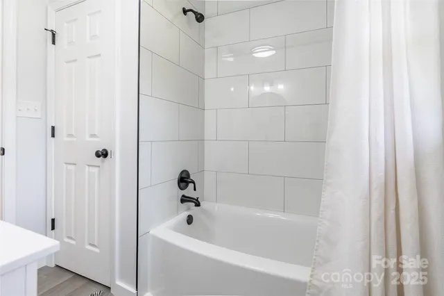 a bathroom with a bathtub and shower