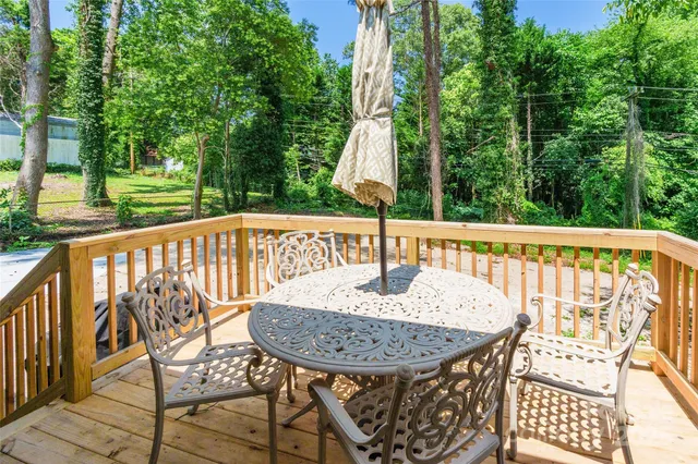 a view of a wooden chairs and table in the patio