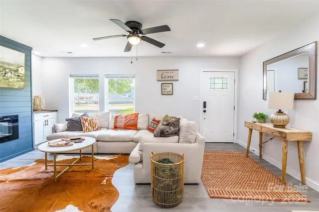 a living room with furniture a window and a chandelier