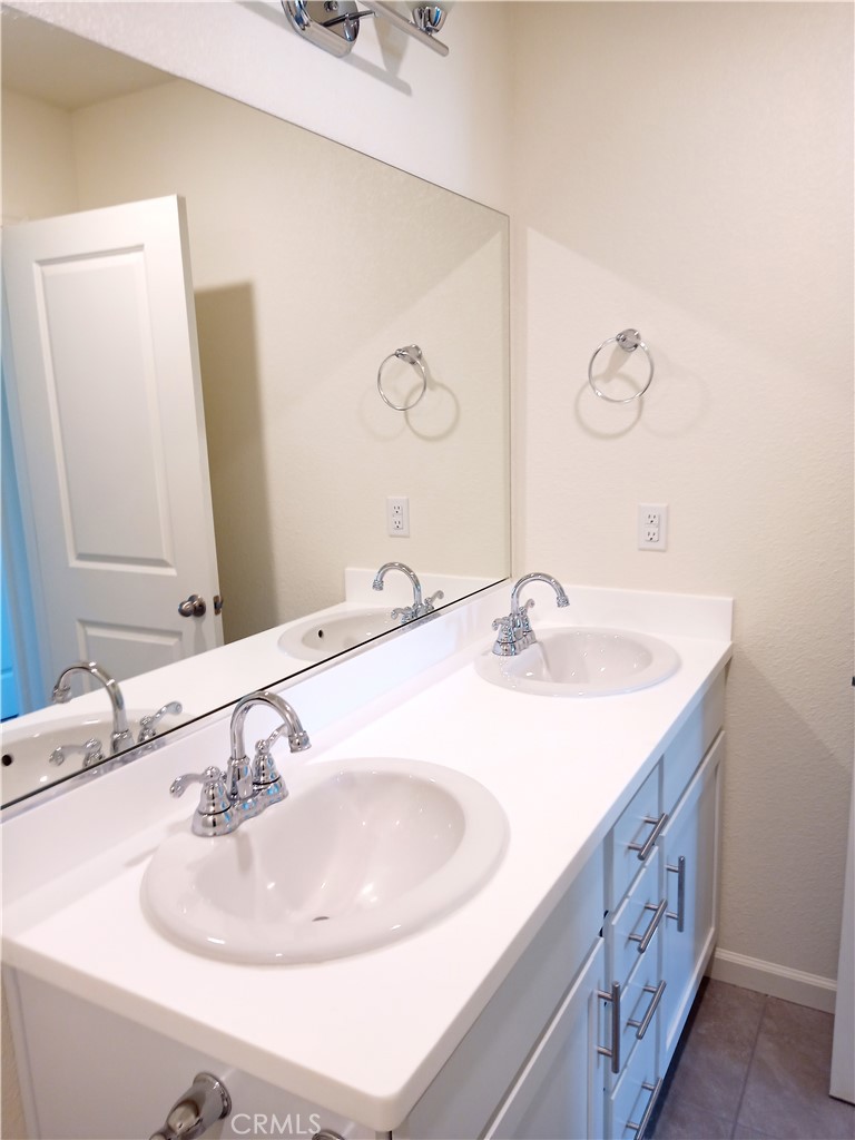 4244 Rutherford Avenue Merced, CA 95348 - Photo 14 of 23 a bathroom with a sink and a mirror