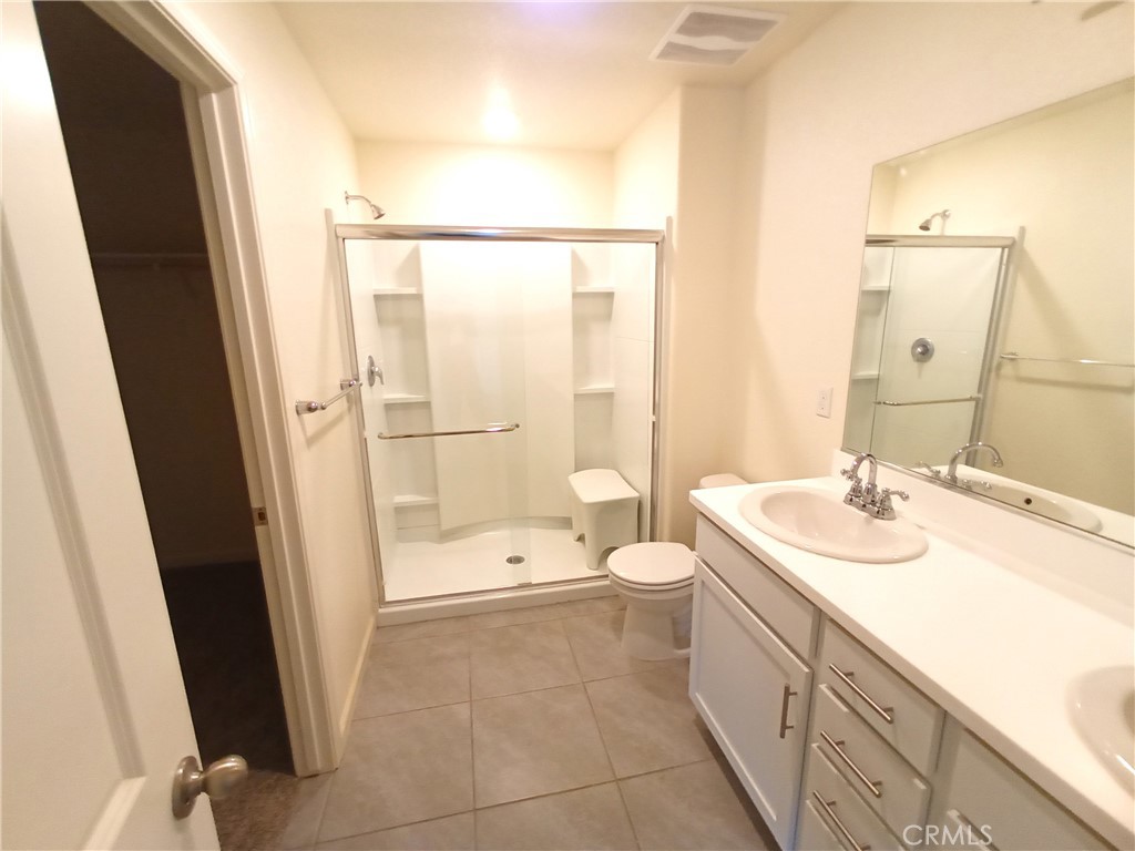 4244 Rutherford Avenue Merced, CA 95348 - Photo 17 of 23 a bathroom with a sink a toilet a mirror and shower