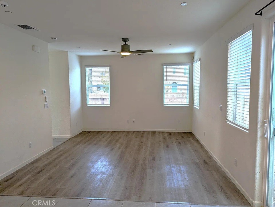 4244 Rutherford Avenue Merced, CA 95348 - Photo 5 of 23 a view of an empty room with wooden floor and a window