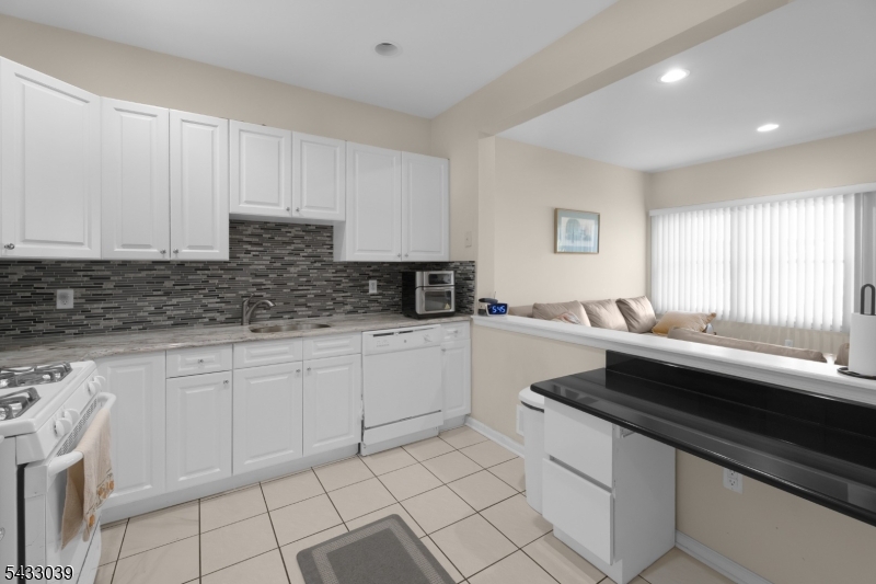 158 Autumn Ridge Road Morris Plains, NJ 07950 - Photo 4 of 26 a kitchen with a sink and cabinets