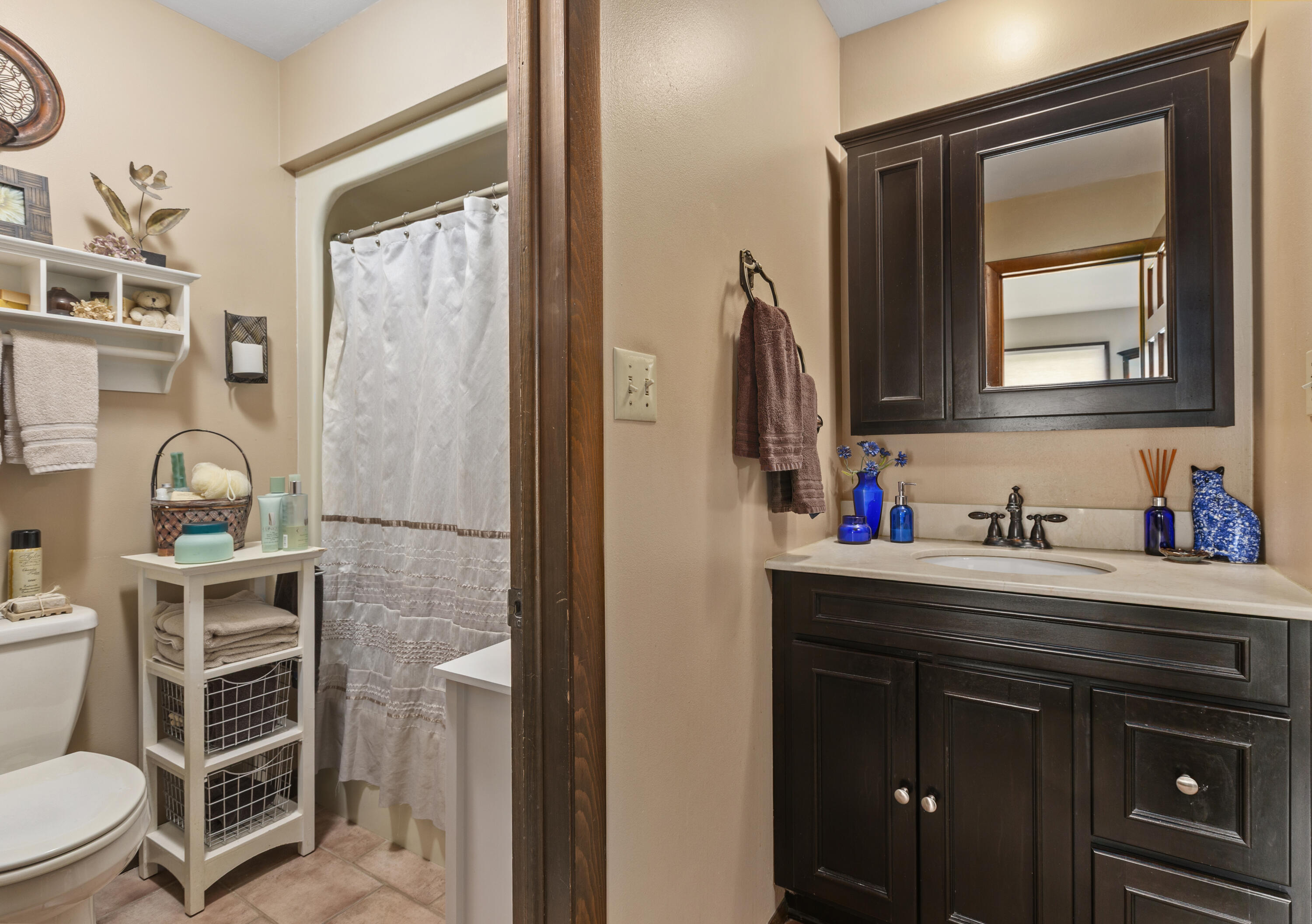 328 East Tratebas Road Valparaiso, IN 46383 - Photo 16 of 48 a bathroom with a toilet sink vanity and a mirror