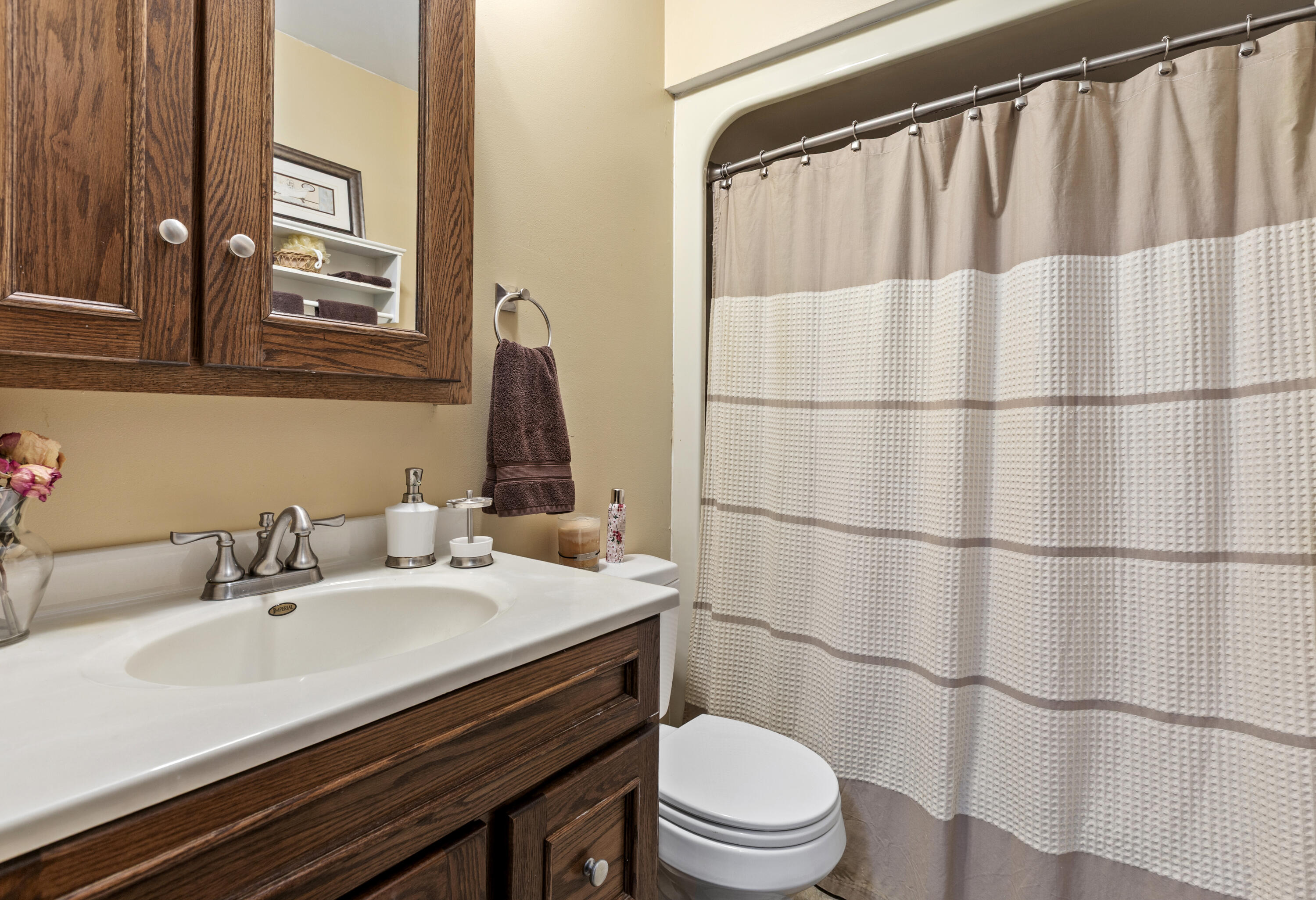 328 East Tratebas Road Valparaiso, IN 46383 - Photo 21 of 48 a bathroom with a sink a toilet a mirror and shower