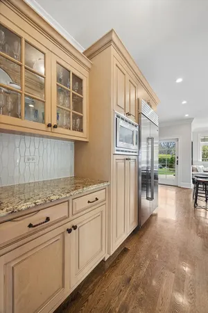 a bathroom with a granite countertop sink a large mirror and shower