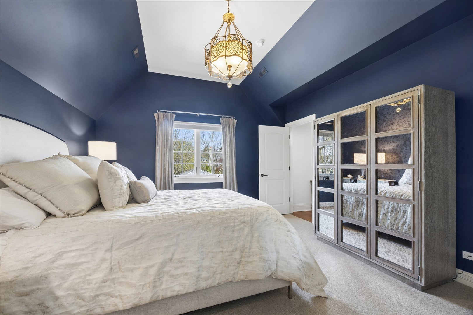 405 Phillippa Street Hinsdale, IL 60521 - Photo 23 of 44 a bedroom with a large bed and a chandelier