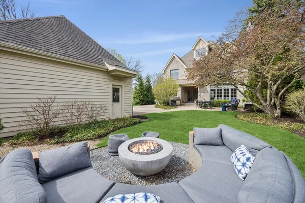 a kitchen with stainless steel appliances granite countertop a stove top oven a sink dishwasher and white cabinets with wooden floor