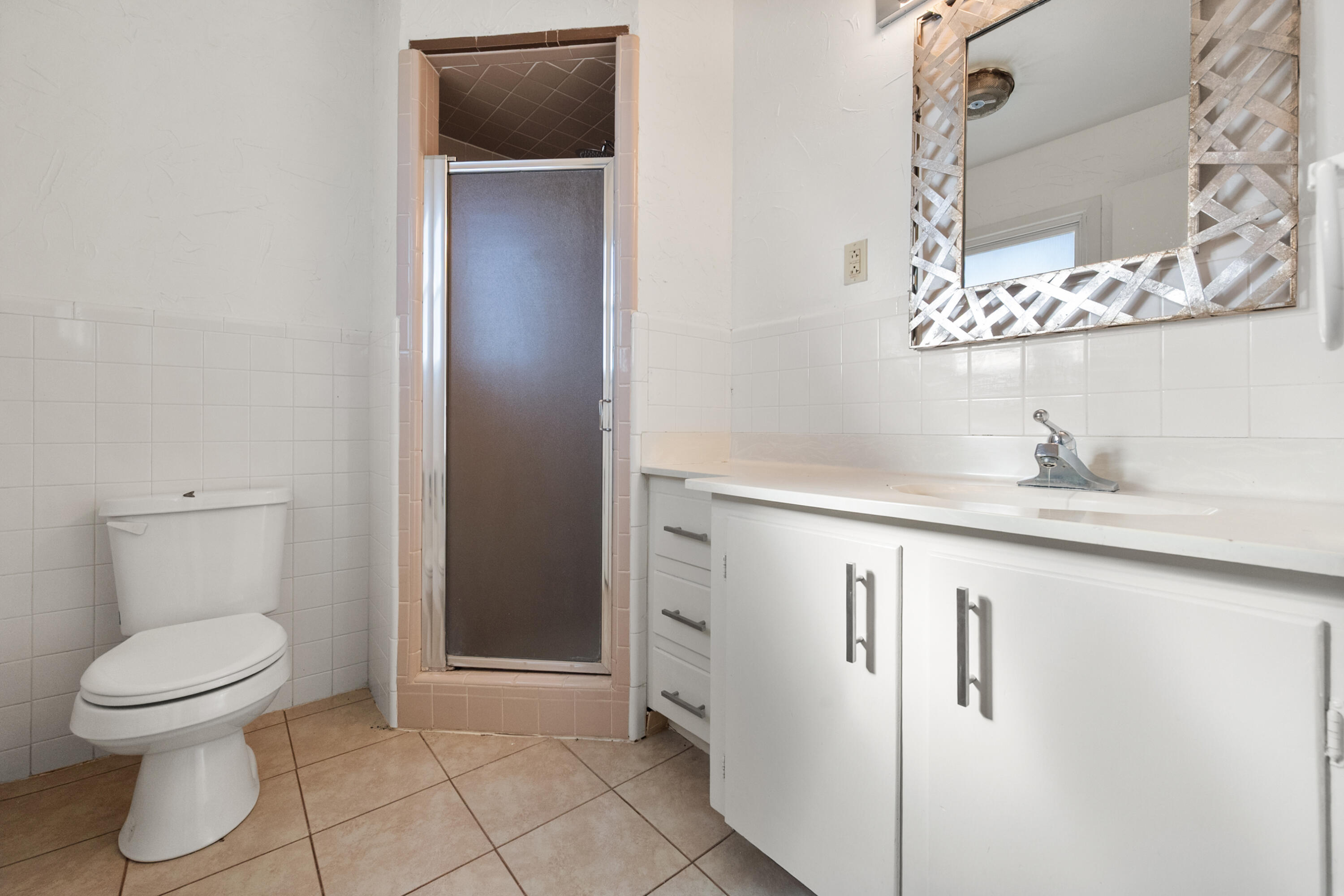 2509 61st Street Lubbock, TX 79413 - Photo 11 of 21 a bathroom with a toilet sink and mirror