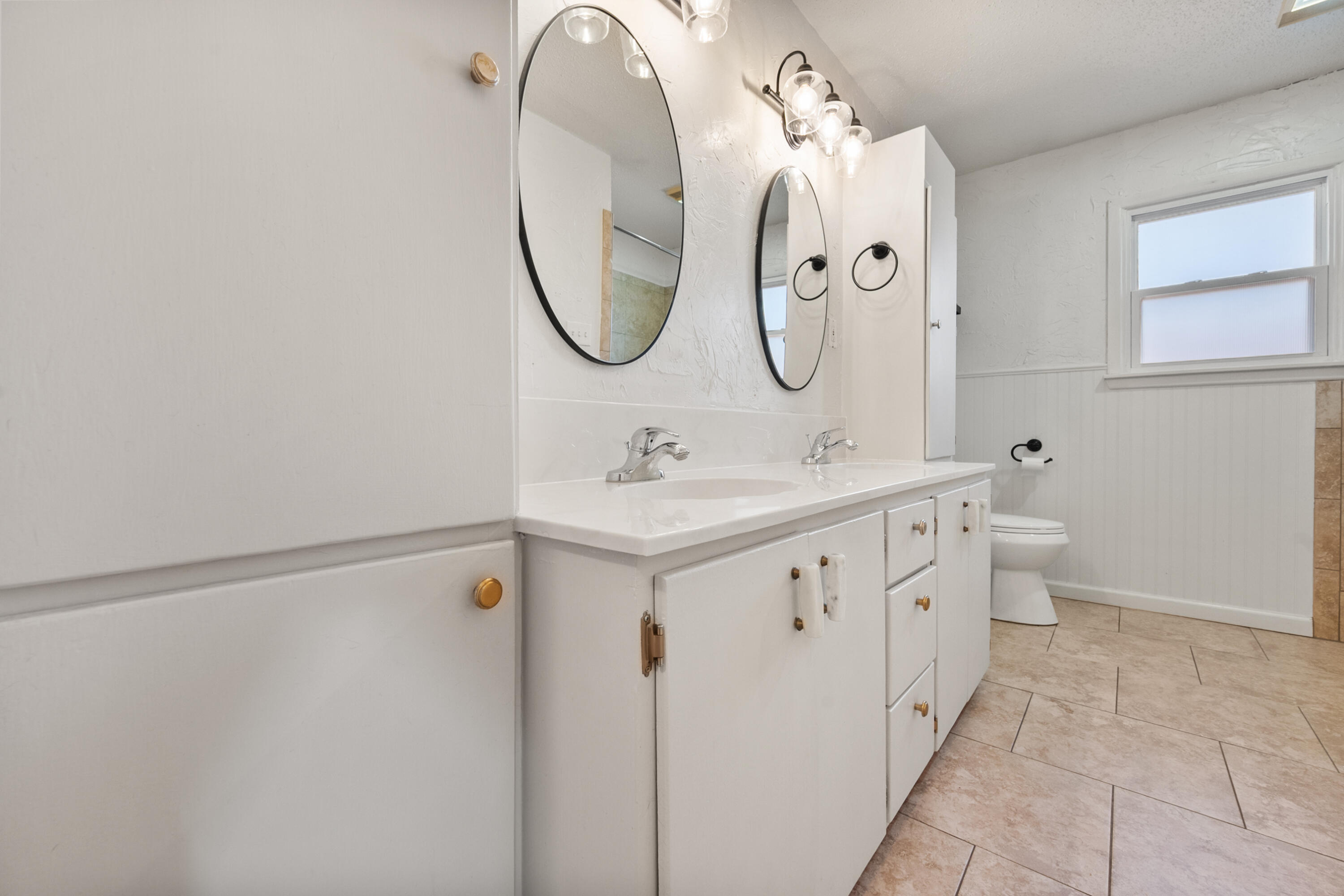 2509 61st Street Lubbock, TX 79413 - Photo 17 of 21 a bathroom with a double vanity sink mirror and toilet