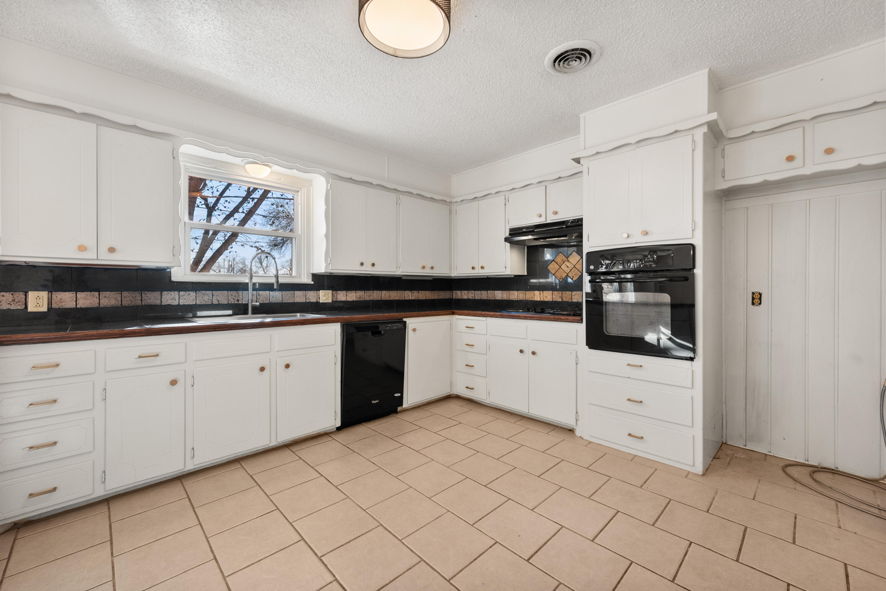 2509 61st Street Lubbock, TX 79413 - Photo 5 of 21 a kitchen with white cabinets stainless steel appliances and sink