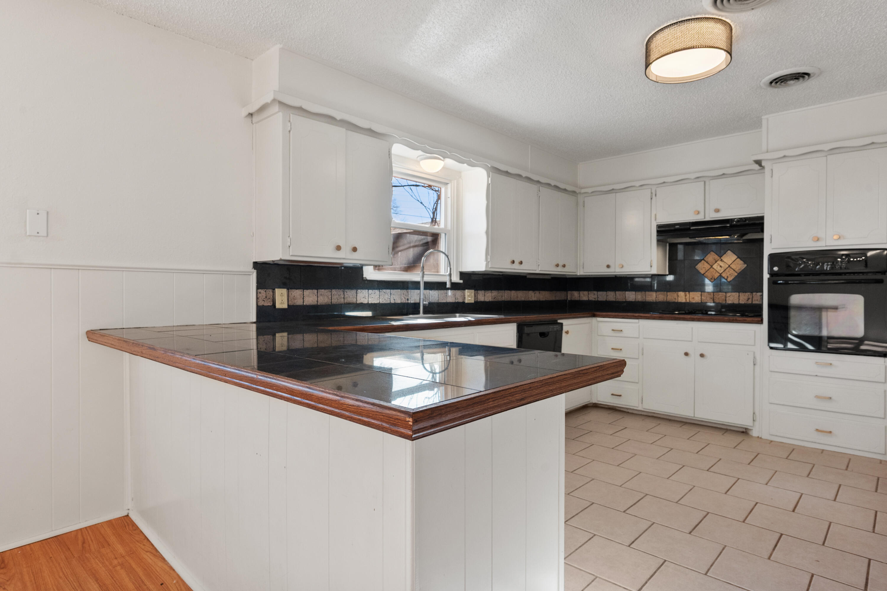 2509 61st Street Lubbock, TX 79413 - Photo 6 of 21 a kitchen with stainless steel appliances granite countertop a sink and a stove
