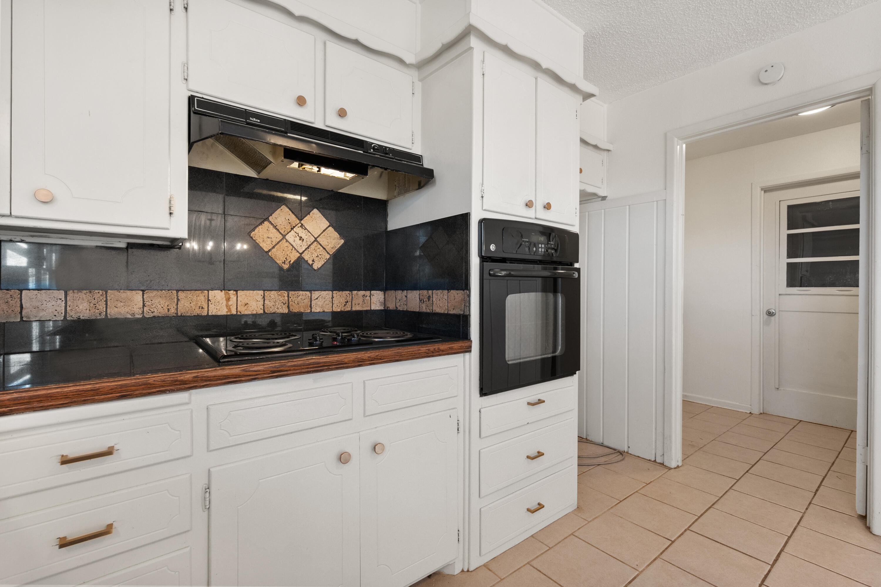 2509 61st Street Lubbock, TX 79413 - Photo 7 of 21 a kitchen with white cabinets and appliances