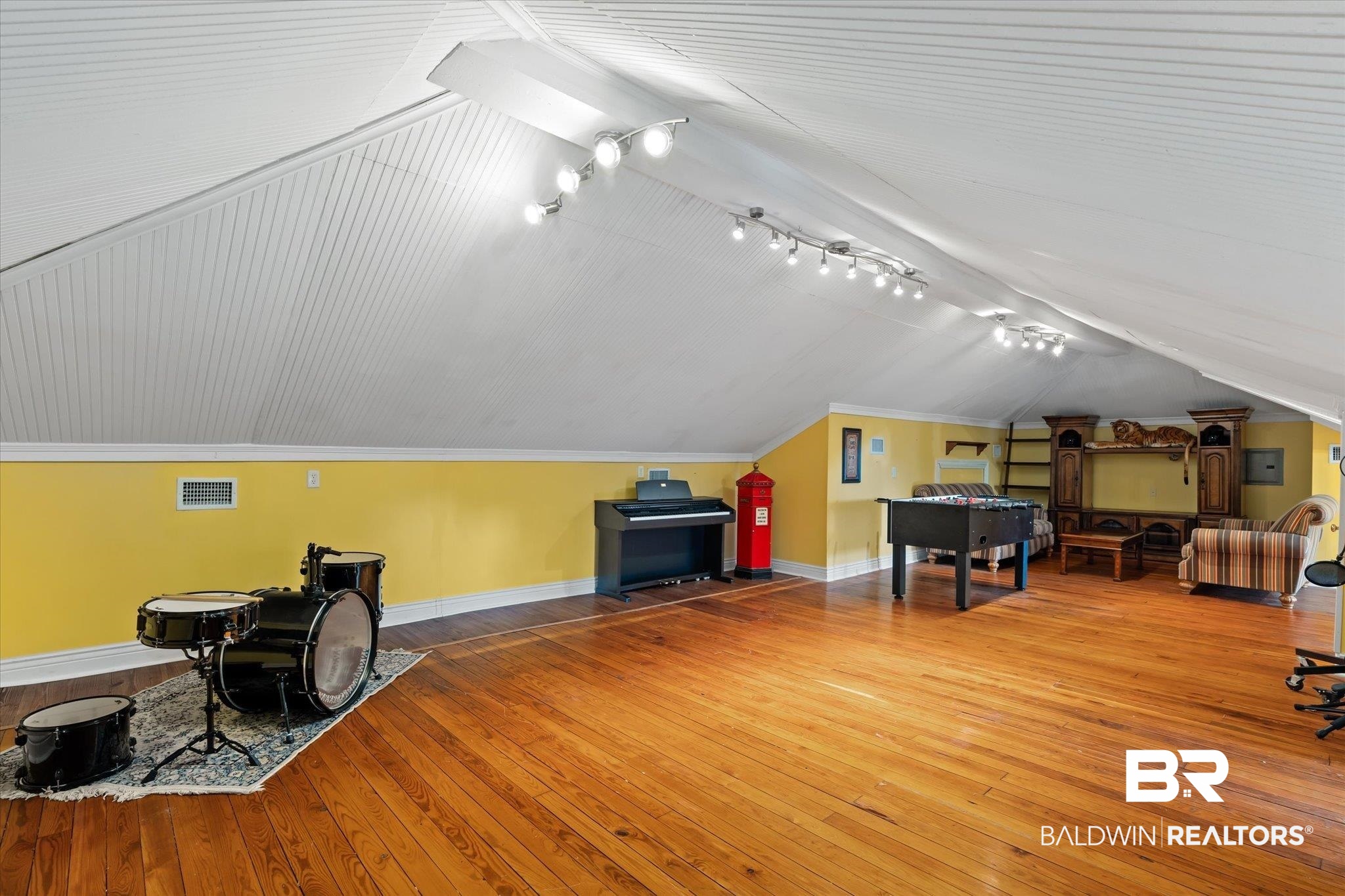 1953 Dauphin Street Mobile, AL 36606 - Photo 27 of 56 Bonus room featuring hardwood / wood-style flooring and vaulted ceiling with skylight