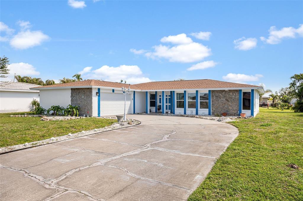 a view of a house with a garden and pathway