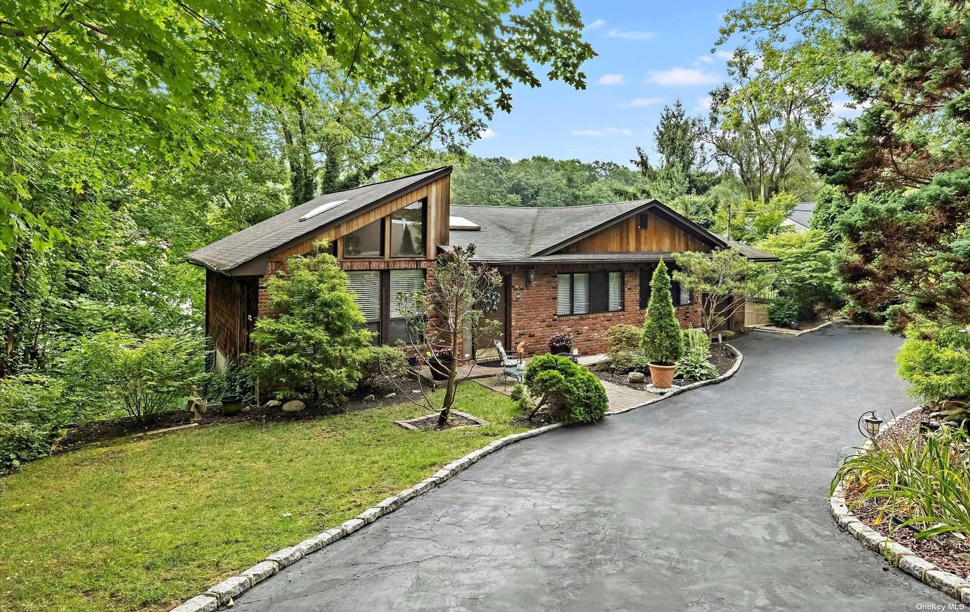 320 Woodbury Road Woodbury, NY 11797 - Photo 1 of 1 a front view of a house with garden