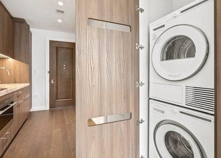 40 Trinity Place, Unit 1518 Boston, MA 02116 - Photo 9 of 25 a view of a kitchen with washer and dryer