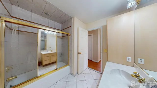 a bathroom with a shower and a sink