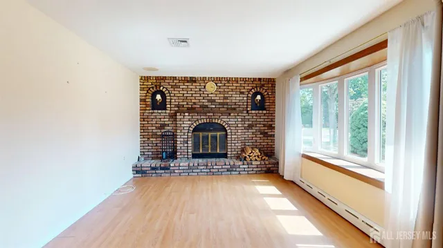 a living room with fireplace furniture and a floor to ceiling window