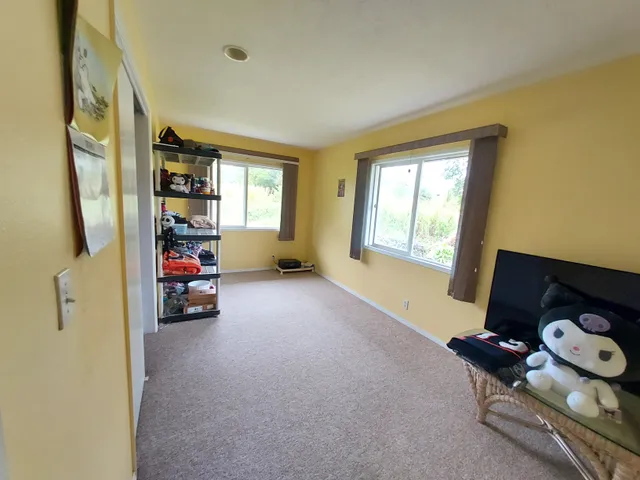 a view of livingroom with furniture and a window