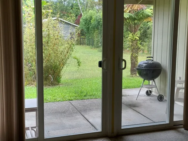 a view of a porch with a table and chairs