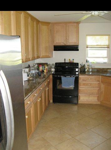 21 Awalau Road Haiku, HI 96708 - Photo 5 of 30 a kitchen with stainless steel appliances granite countertop a stove a sink and a refrigerator