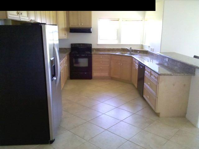 21 Awalau Road Haiku, HI 96708 - Photo 6 of 30 a kitchen with granite countertop a refrigerator and a stove