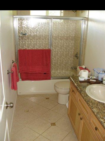 21 Awalau Road Haiku, HI 96708 - Photo 8 of 30 a bathroom with a granite countertop sink toilet and shower