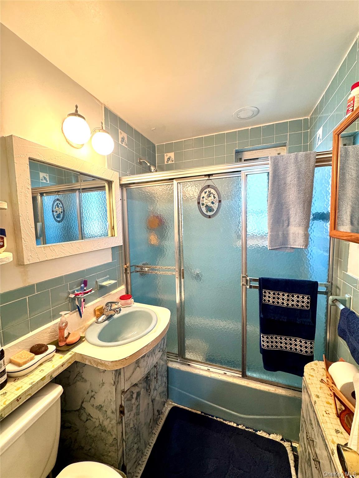 224-20 Manor Road, Unit 91 Queens, NY 11427 - Photo 13 of 17 a bathroom with a sink and mirror