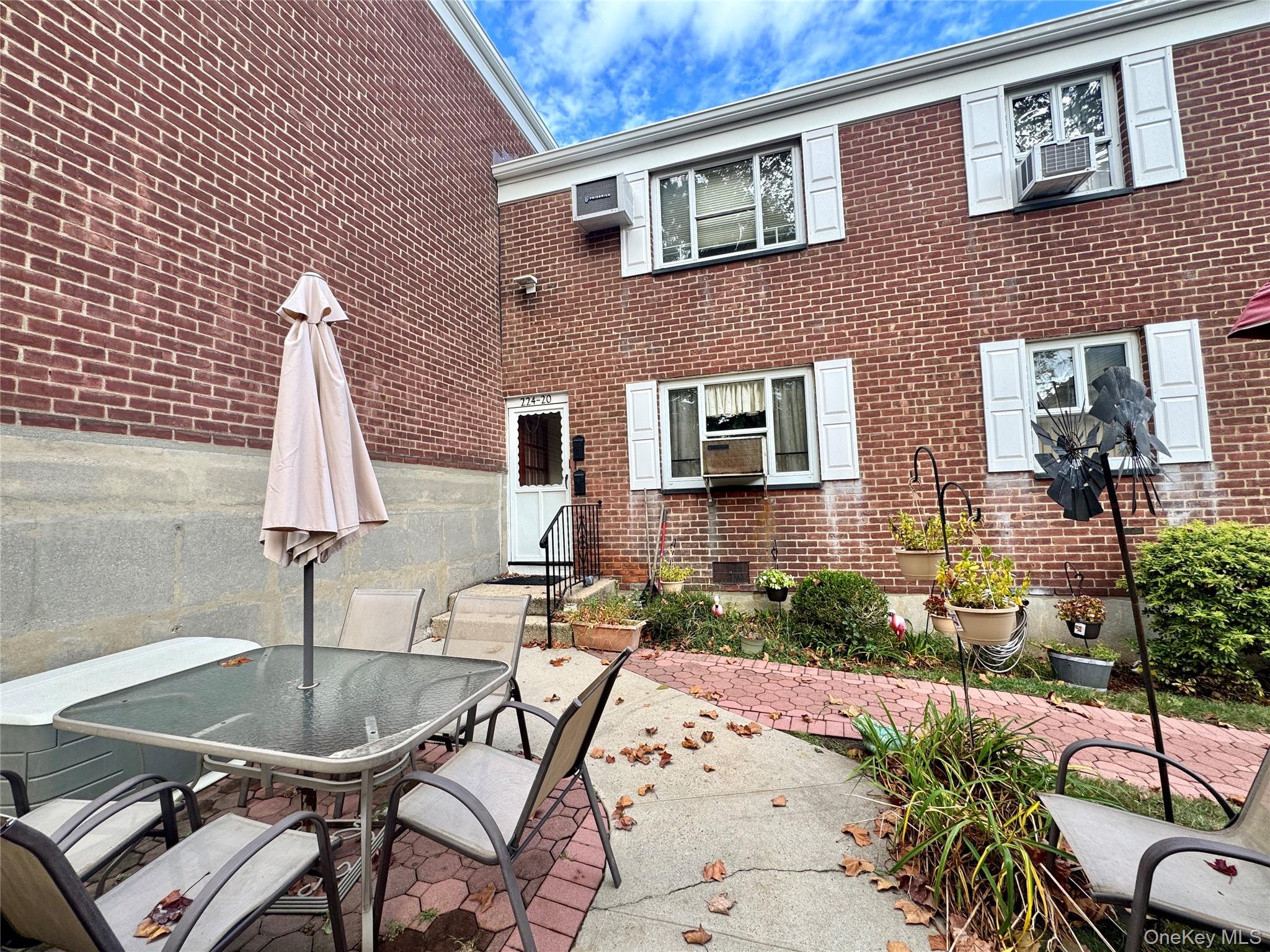 224-20 Manor Road, Unit 91 Queens, NY 11427 - Photo 2 of 17 a view of a patio with chairs and plants