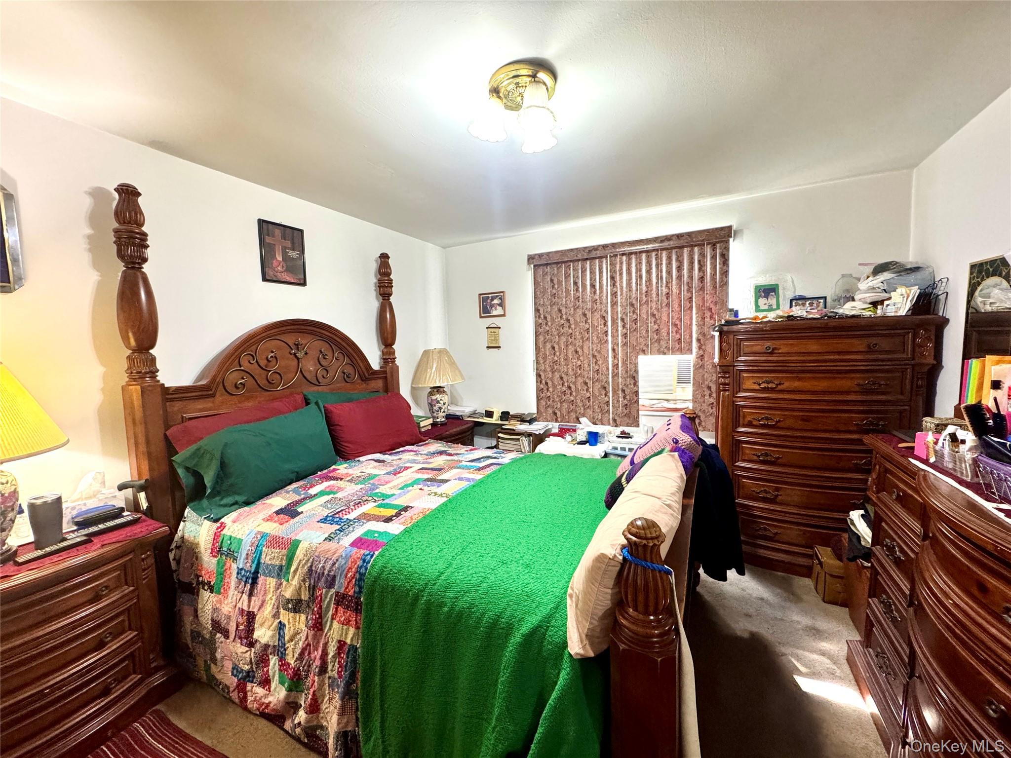 224-20 Manor Road, Unit 91 Queens, NY 11427 - Photo 9 of 17 a bedroom with a bed table and a window