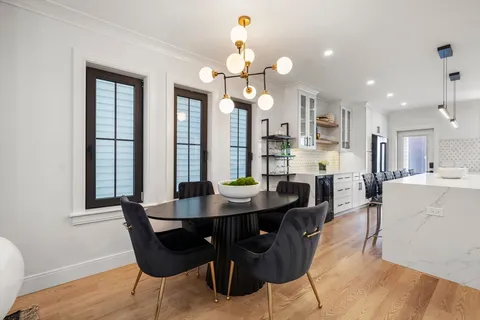 a view of a dining room with furniture and a chandelier