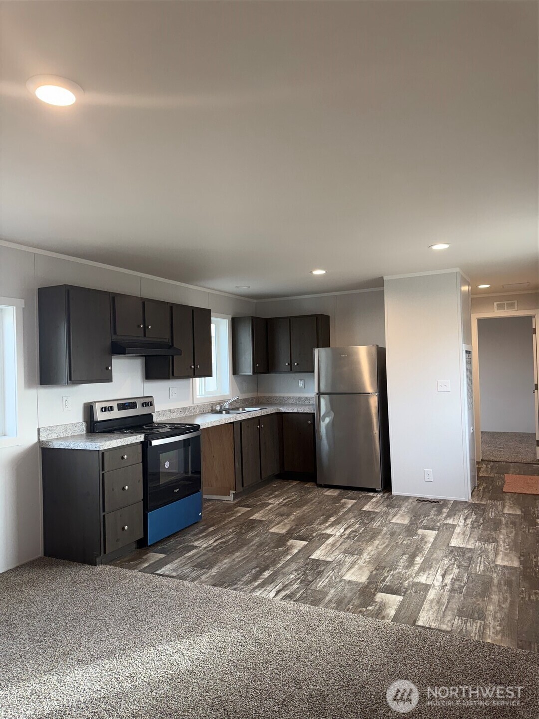 200 West Hawthorn Street, Unit 32 Connell, WA 99326 - Photo 11 of 16 a large kitchen with stainless steel appliances granite countertop a refrigerator and a sink
