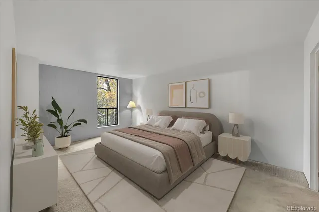 a bedroom with a large bed and a potted plant