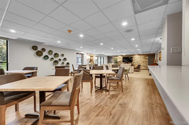 a view of a dining hall with furniture and wooden floor