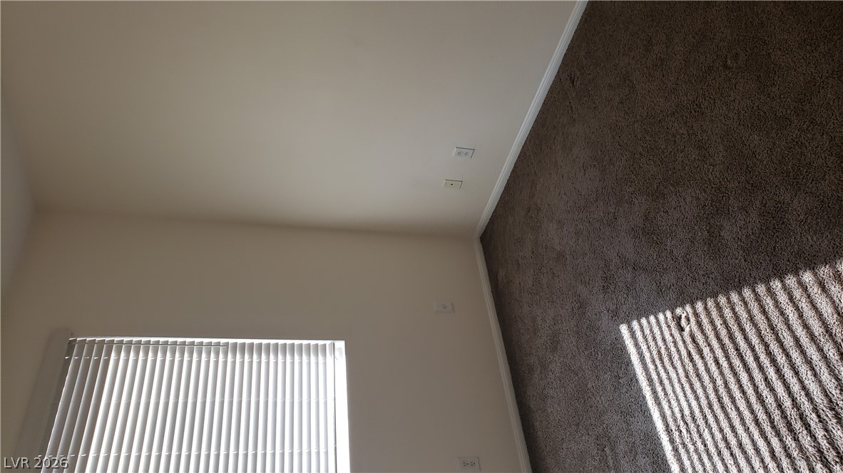 9112 Manalang Road Las Vegas, NV 89123 - Photo 41 of 50 Well-lit room with plush carpeting and natural light filtering through window blinds.
