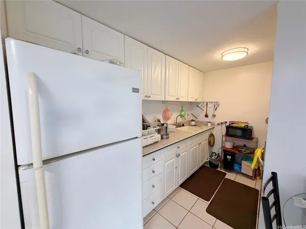 a kitchen with a refrigerator sink and cabinets