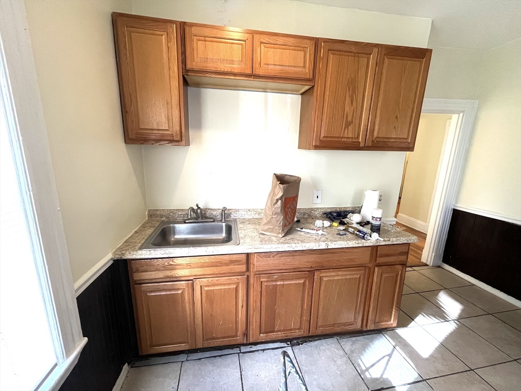 15 Wentworth Street, Unit 1 Boston, MA 02124 - Photo 13 of 14 a kitchen with sink cabinets and stove