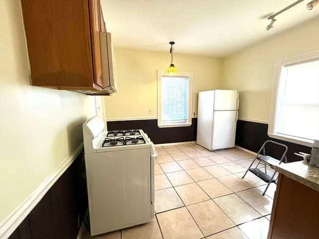 a kitchen with a sink appliances and cabinets