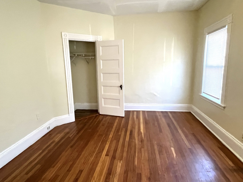 15 Wentworth Street, Unit 1 Boston, MA 02124 - Photo 2 of 14 an empty room with wooden floor and windows
