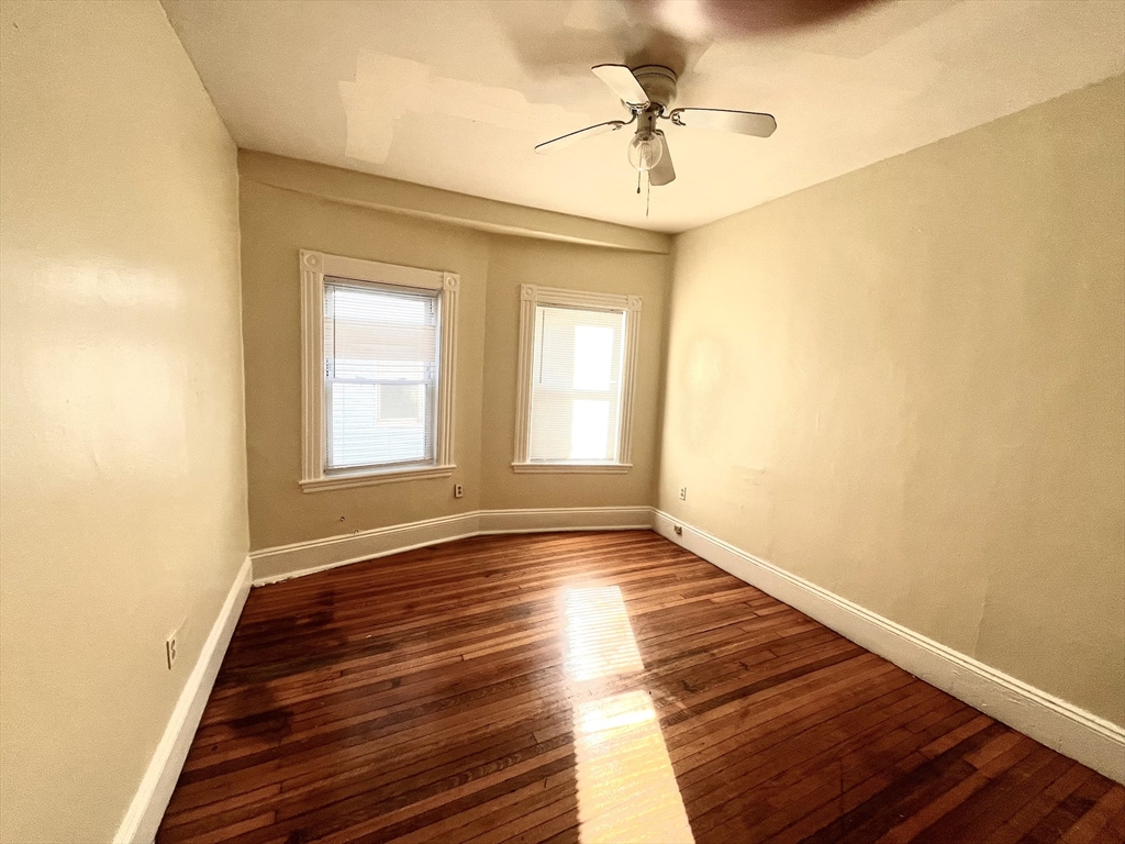 15 Wentworth Street, Unit 1 Boston, MA 02124 - Photo 6 of 14 a view of an empty room with window and wooden floor