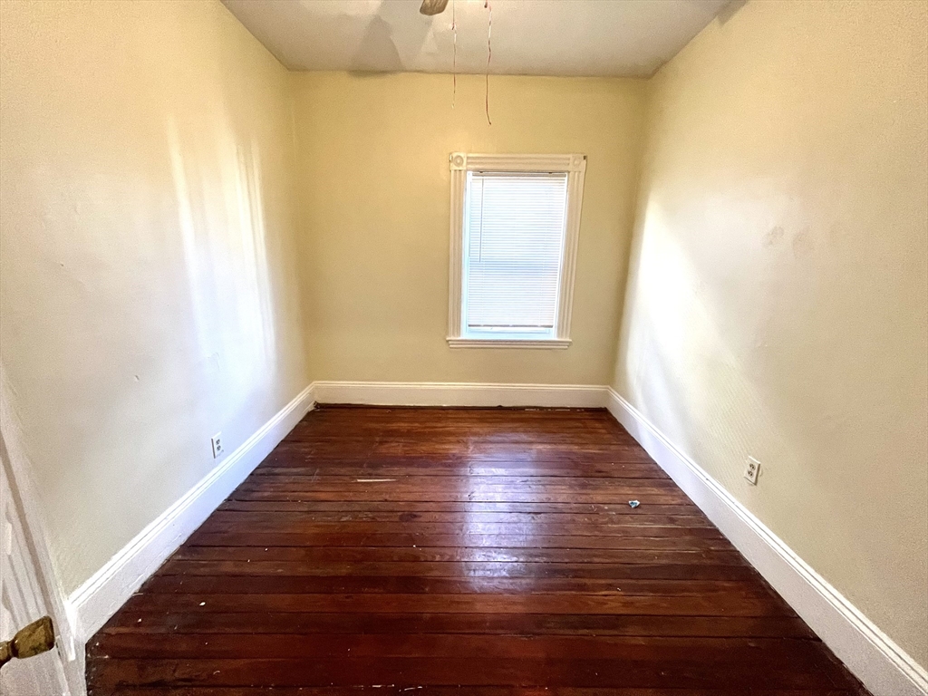 15 Wentworth Street, Unit 1 Boston, MA 02124 - Photo 10 of 14 a view of an empty room with wooden floor and a window