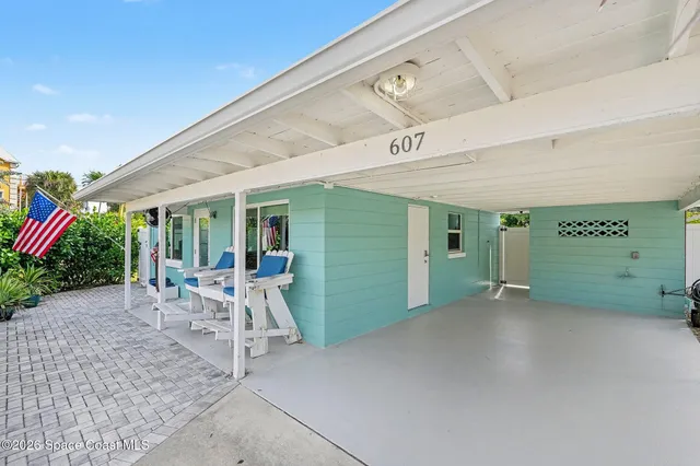 a view of a patio with a table and chairs under an umbrella