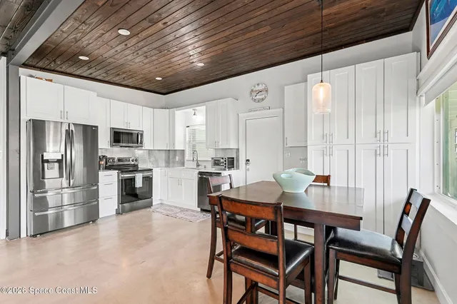 a view of a dining room with furniture window and kitchen