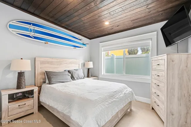 a bedroom with a bed and a dresser