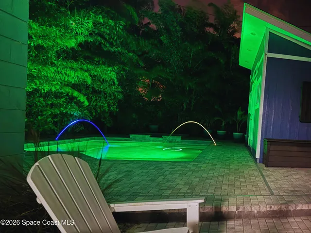 a view of a two chairs in a backyard