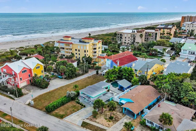 an aerial view of a houses with an outdoor space and seating